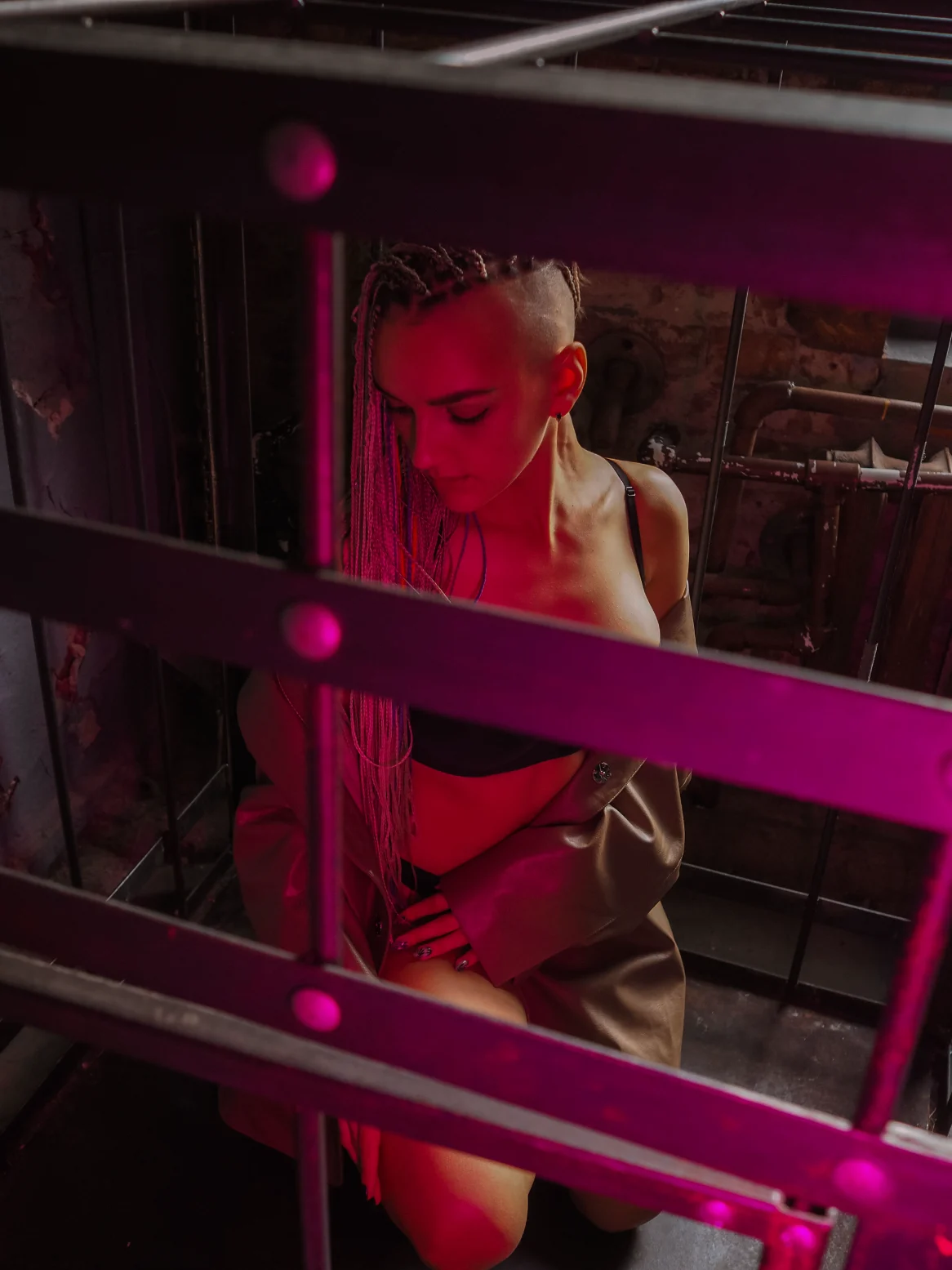 Red-lit figure behind bars